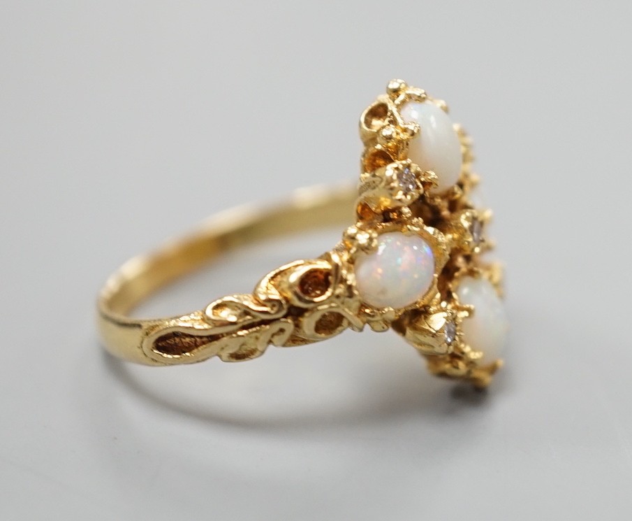A 1970's 18ct gold, white opal and diamond chip set quatrefoil shaped ring, size O, gross weight 6.1 grams.